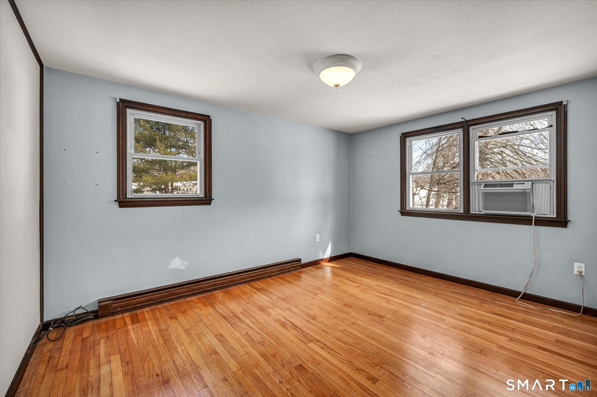 147 Tuttle Road Durham, CT 06422 - Photo 23 of 38 a view of an empty room with window and wooden floor