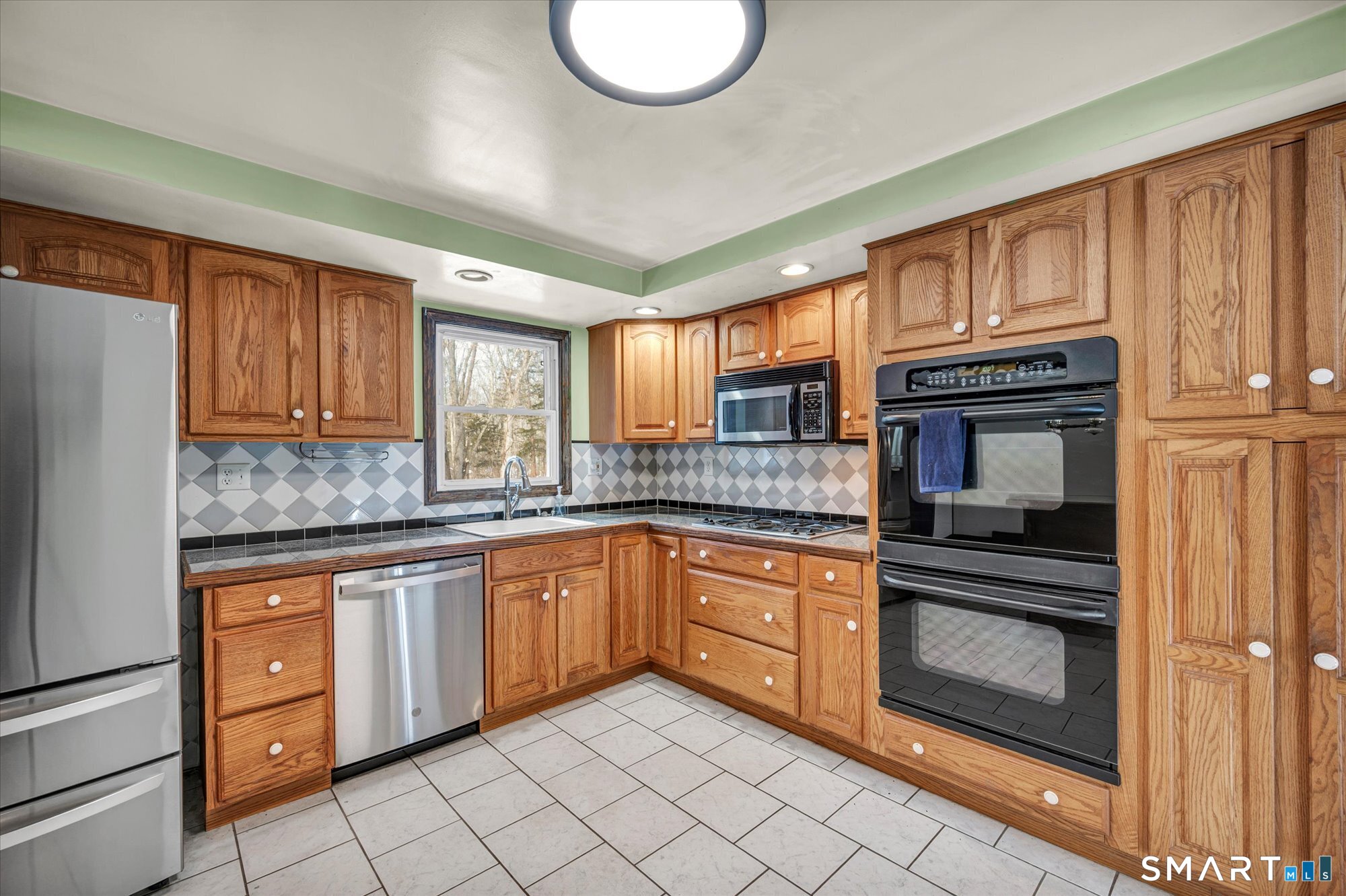 147 Tuttle Road Durham, CT 06422 - Photo 31 of 38 a kitchen with granite countertop cabinets stainless steel appliances and a sink
