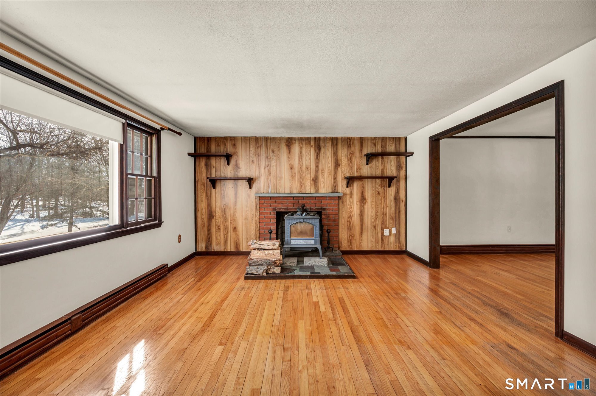 147 Tuttle Road Durham, CT 06422 - Photo 7 of 38 a view of a hallway with wooden floor and a refrigerator