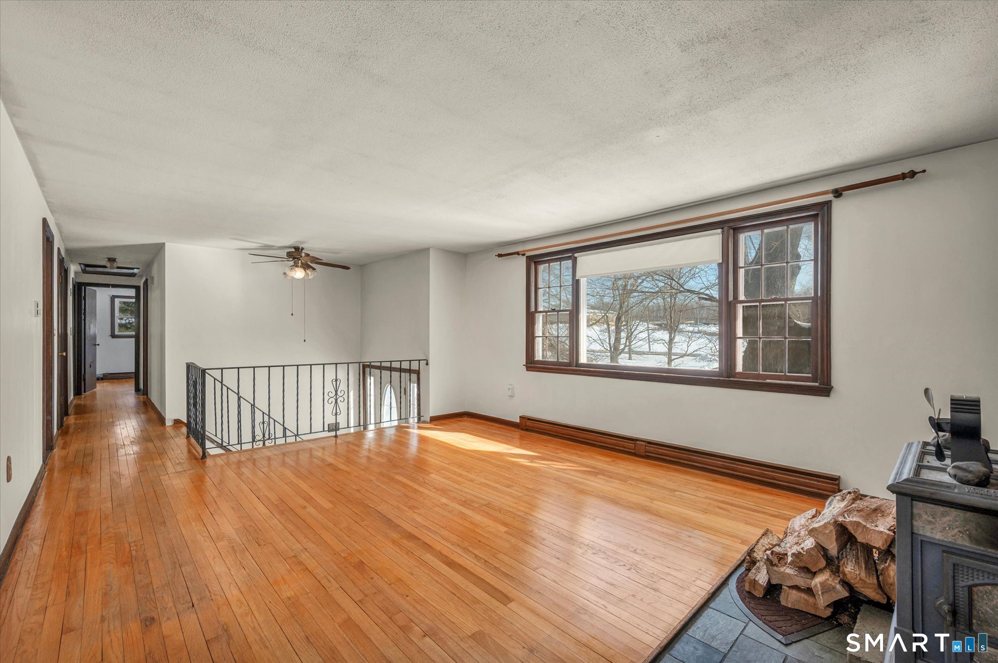 147 Tuttle Road Durham, CT 06422 - Photo 9 of 38 a view of an empty room with wooden floor and a window