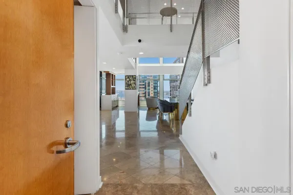 a view of entryway and hall with wooden floor