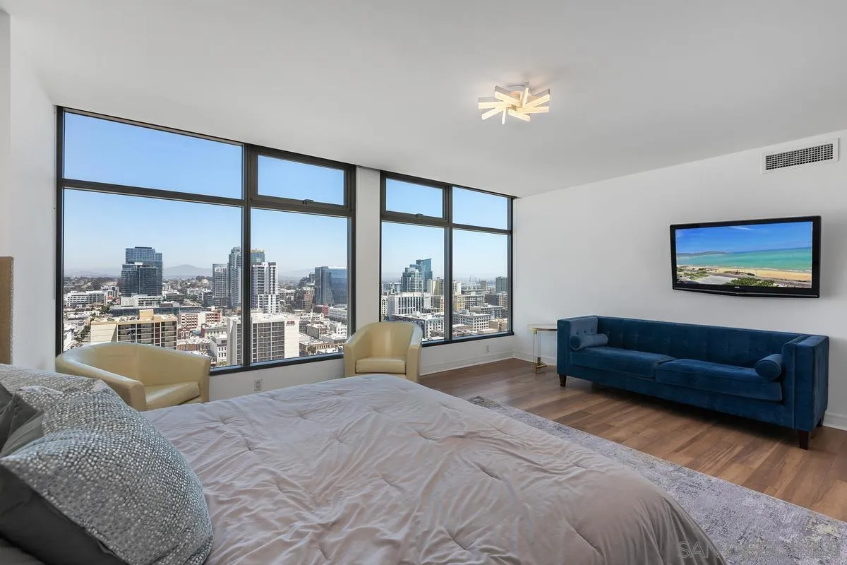 645 Front Street, Unit 2004 San Diego, CA 92101 - Photo 31 of 47 a spacious bedroom with a large bed and a large window