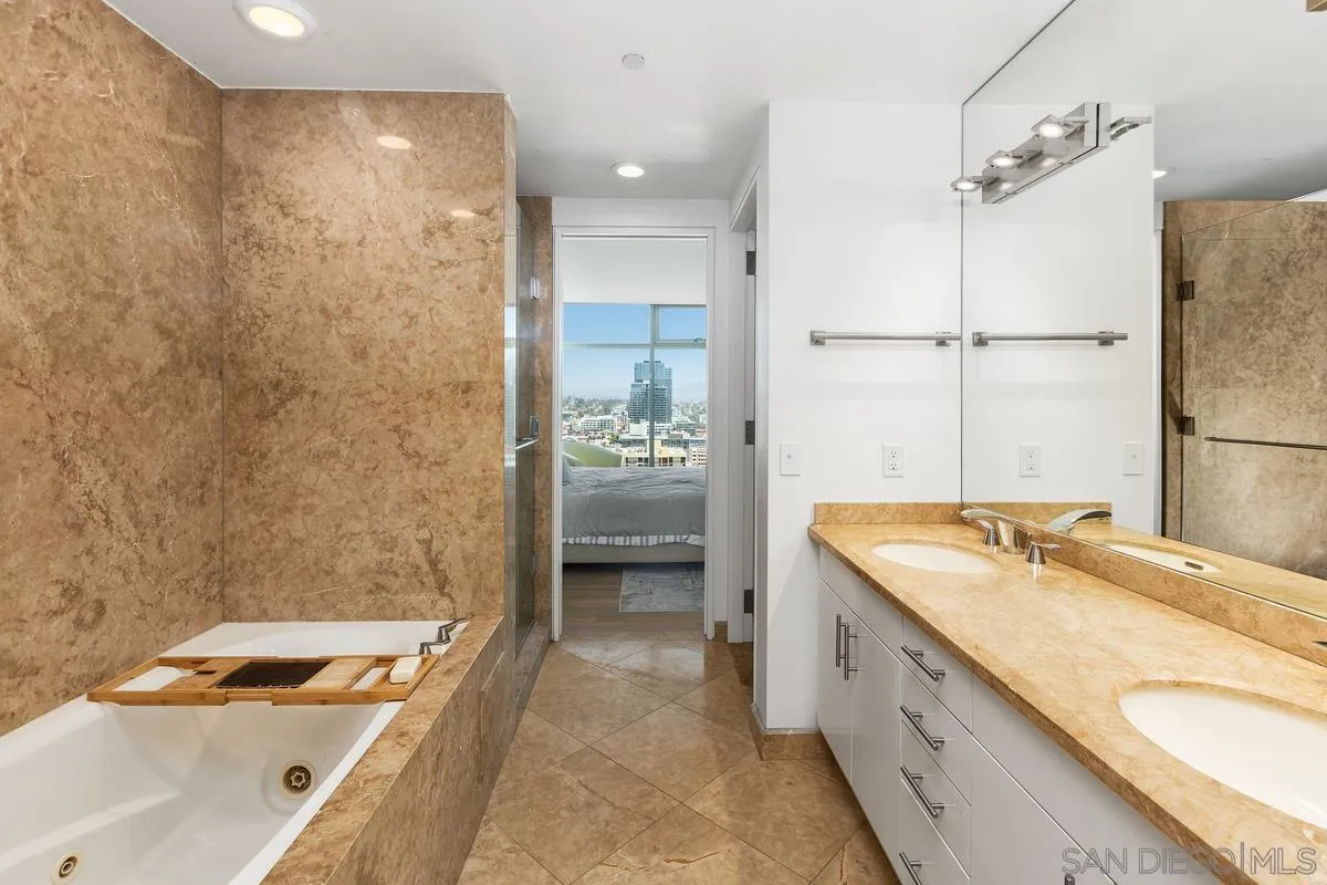 645 Front Street, Unit 2004 San Diego, CA 92101 - Photo 33 of 47 a bathroom with a granite countertop sink and a tub