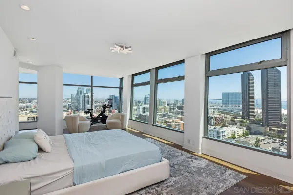 a living room with furniture and a floor to ceiling window