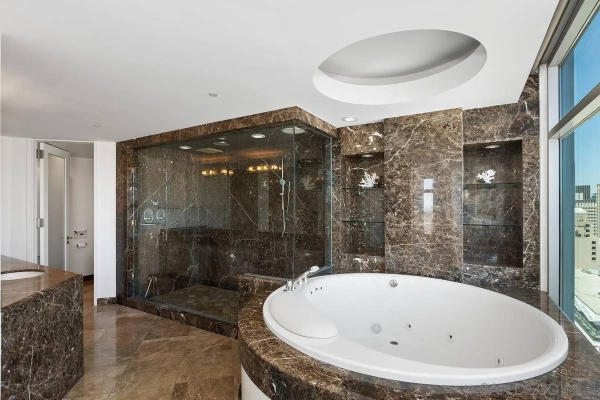 645 Front Street, Unit 2004 San Diego, CA 92101 - Photo 37 of 47 a bathroom with a bathtub and shower