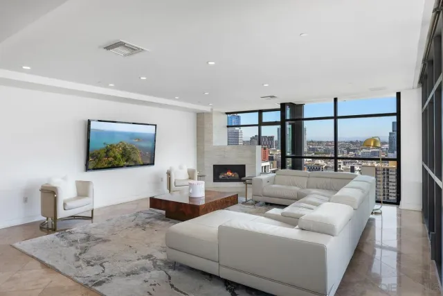 a living room with furniture a large window and a flat screen tv