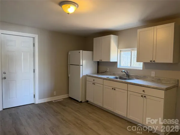 a white refrigerator freezer sitting inside of a kitchen
