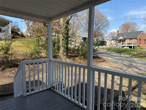 a view of a porch with wooden floor and roof with floor to ceiling window