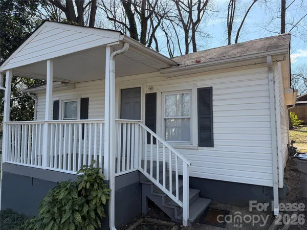 a view of a house with a small yard