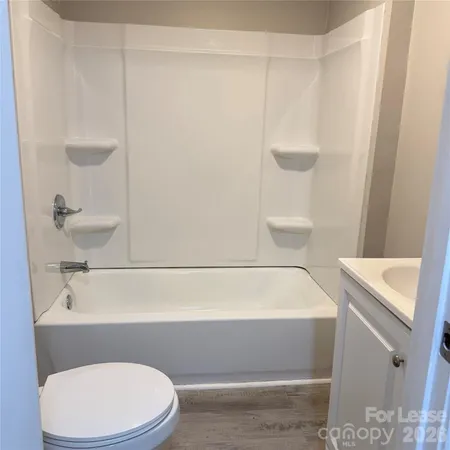 a bathroom with a sink a toilet and bathtub