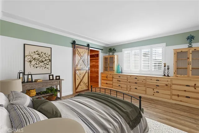 a bedroom with furniture and a window