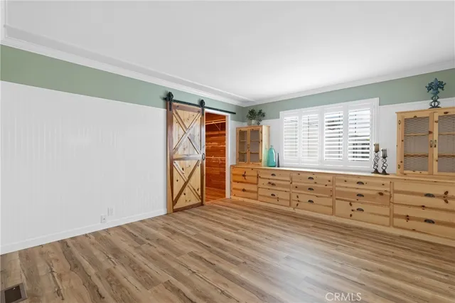 a view of room with window and wooden floor