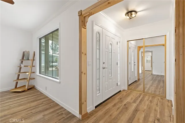 a view of a hallway with wooden floor and staircase