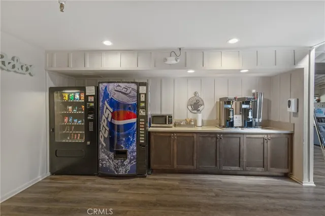 a kitchen with stainless steel appliances granite countertop a refrigerator and microwave