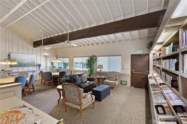 a living room with furniture and a book shelf