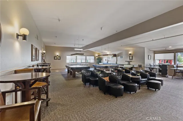 a living room with lots of furniture and a book shelf