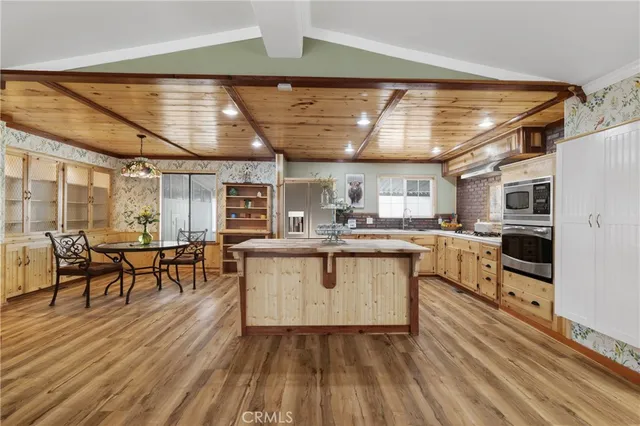 a kitchen with counter top space and wooden floor