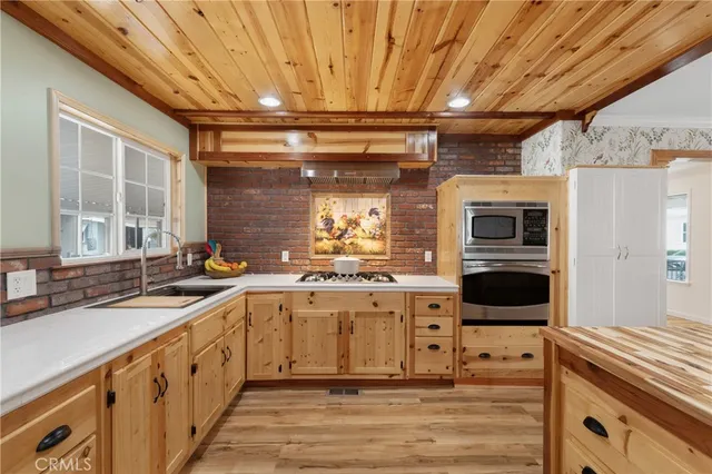 a kitchen with a sink stove and cabinets