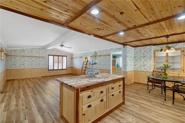 a room with a table chairs and wooden floor