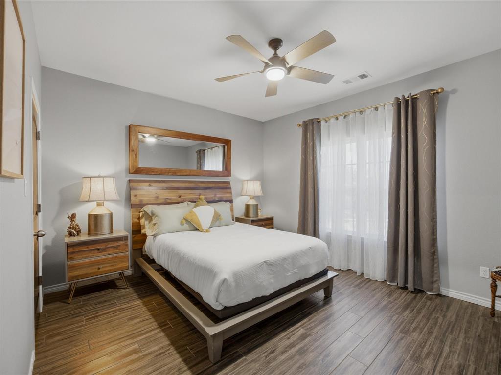 117 Ranchview Court Bowie, TX 76230 - Photo 18 of 40 a bedroom with a bed and a chandelier