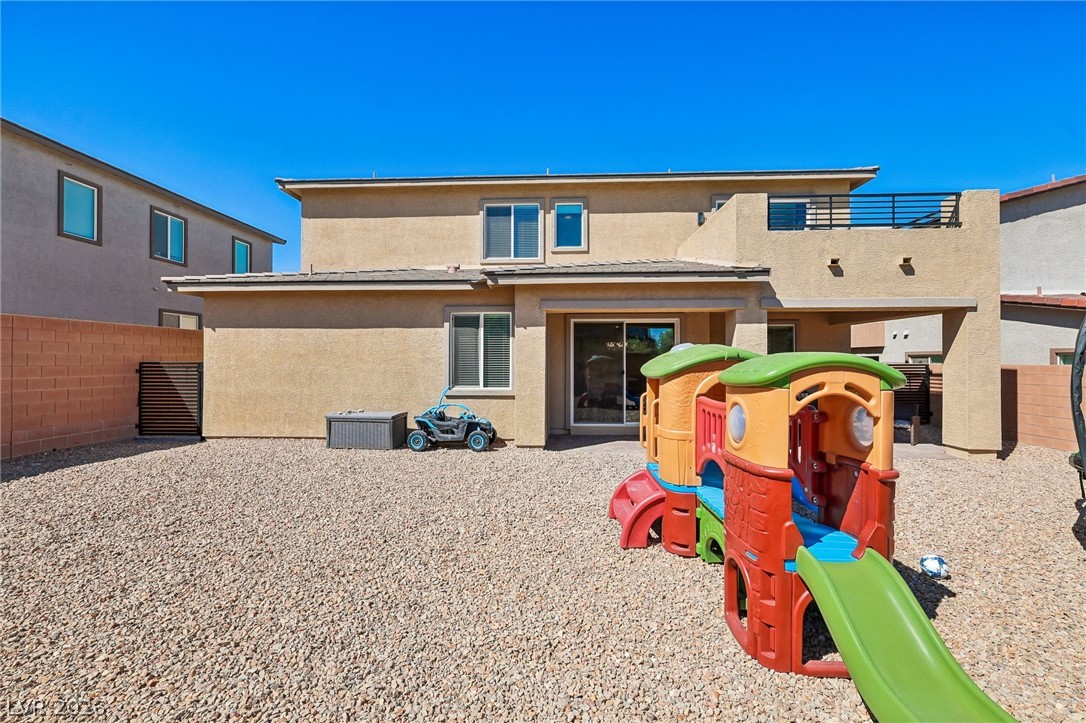 194 Viento Ridge Street Henderson, NV 89012 - Photo 56 of 72 An expansive gravel backyard highlights the rear exterior of this two-story stucco residence.