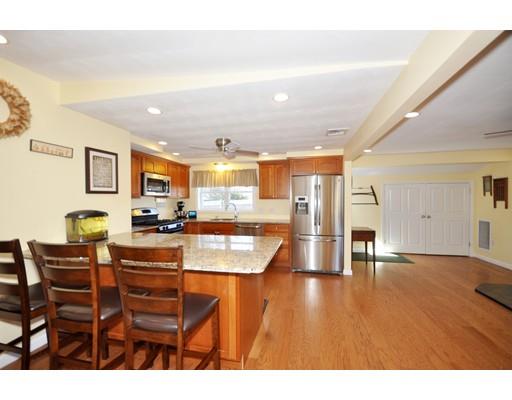 16 Judith Road Chelmsford, MA 01824 - Photo 1 of 14 a living room with stainless steel appliances kitchen island granite countertop a table chairs and a refrigerator