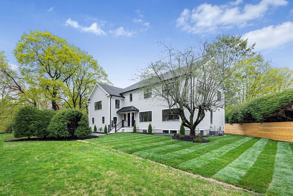 9 Smith Street Wellesley, MA 02482 - Photo 1 of 1 a view of a white house with a big yard and large tree