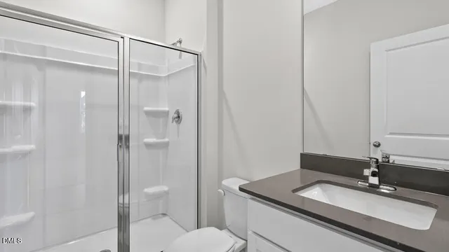 a bathroom with a sink double vanity granite tub shower and a mirror