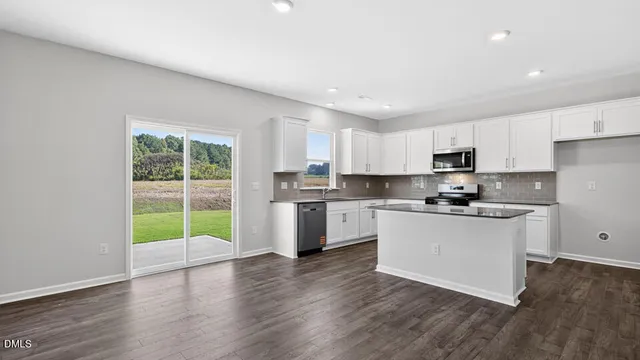 a view of a kitchen with a sink and a refrigerator