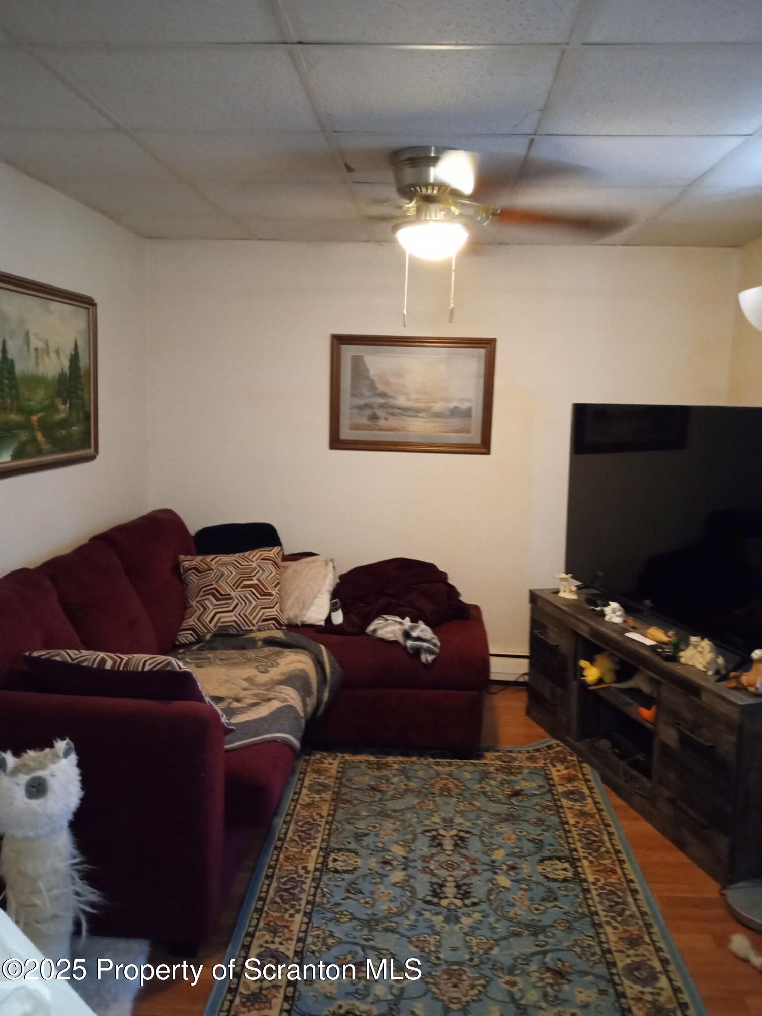 3061-3065 Main Street Clarks Summit, PA 18411 - Photo 21 of 34 a living room with furniture and a flat screen tv