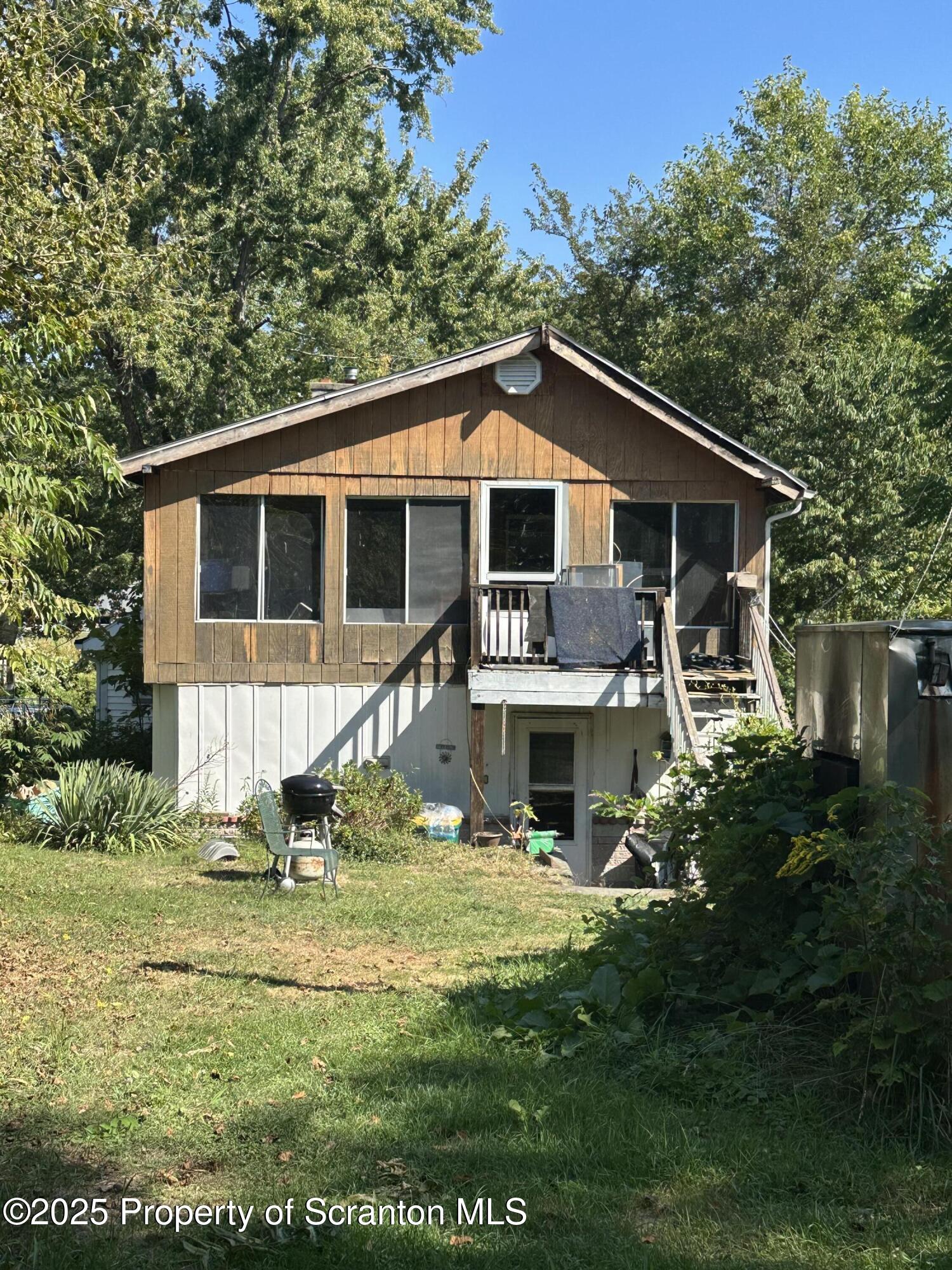 3061-3065 Main Street Clarks Summit, PA 18411 - Photo 7 of 34 a front view of a house with a yard