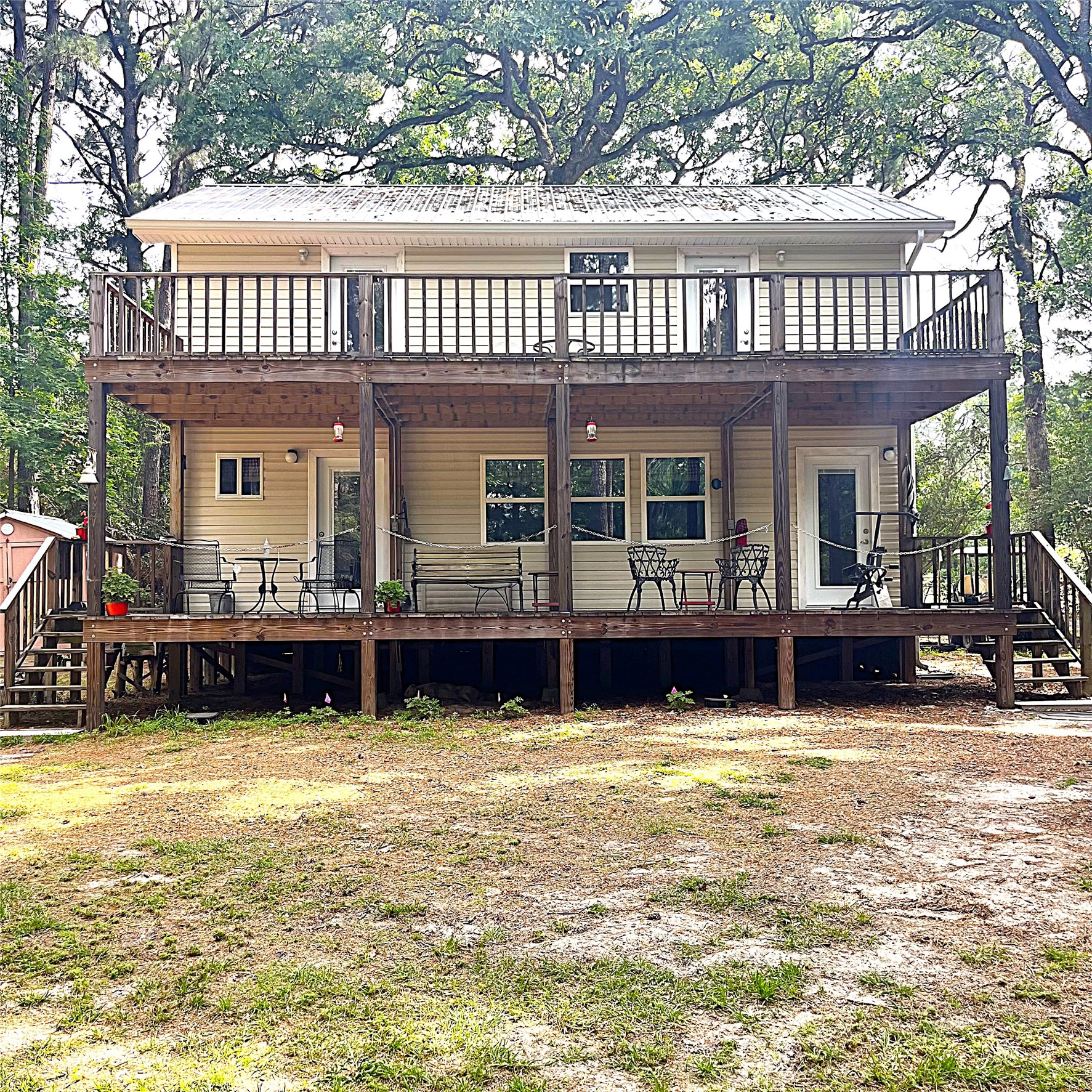 a view of a swimming pool with lawn chairs and a yard with swimming pool