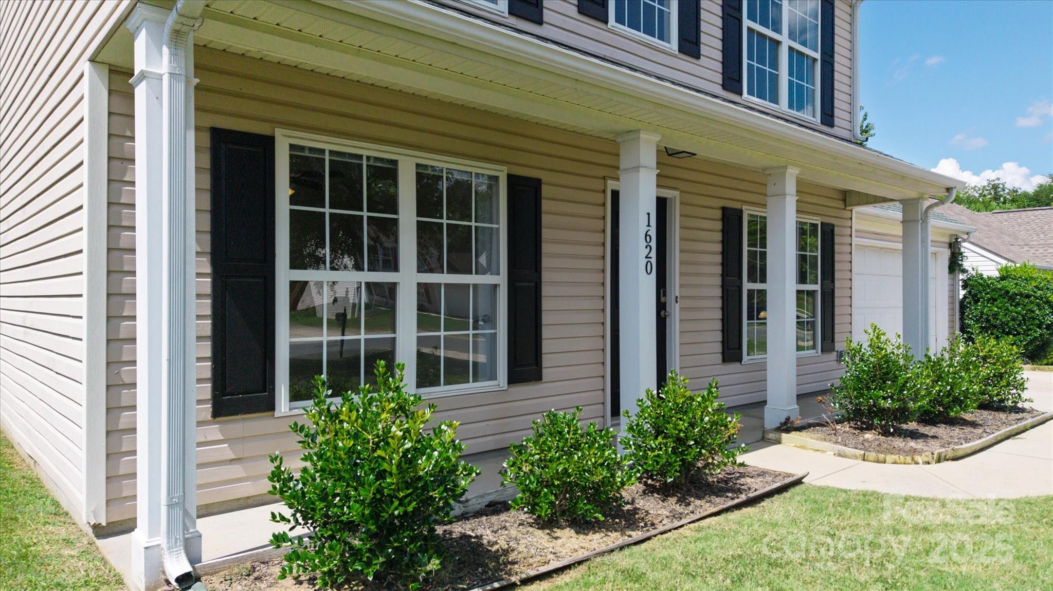 1620 Tate Road Rock Hill, SC 29732 - Photo 3 of 33 front view of a brick house with a large window and potted plants