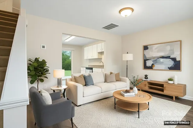 a living room with furniture and a potted plant
