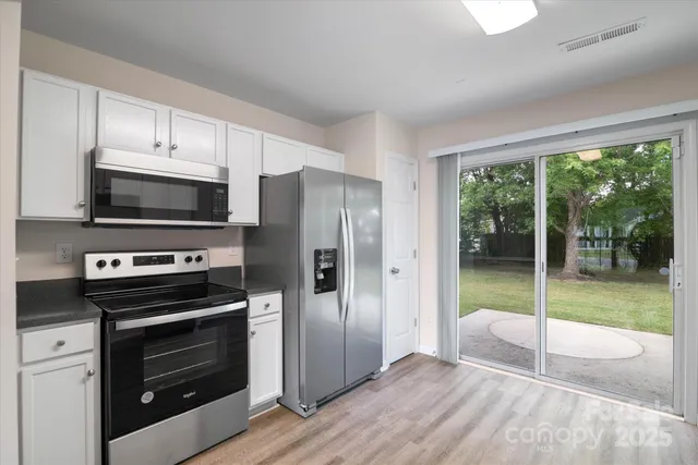 a kitchen with a stove a microwave and a refrigerator