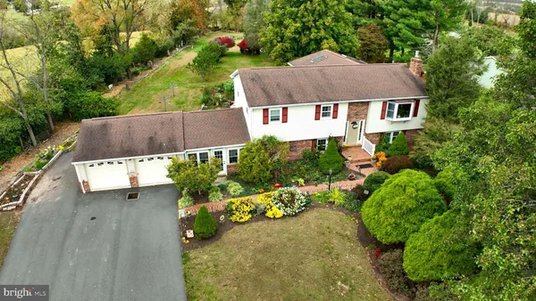 an aerial view of a house with a yard and potted plants