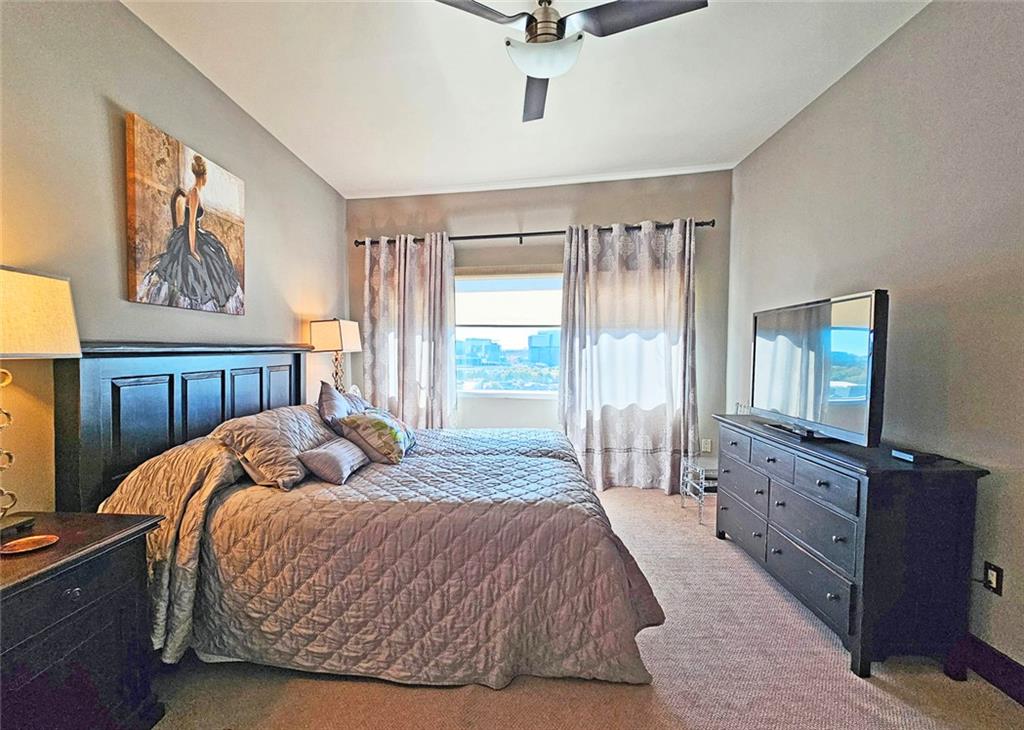 4561 Olde Perimeter Way, Unit 1202 Atlanta, GA 30346 - Photo 13 of 46 a bedroom with a bed a dresser and next to a window