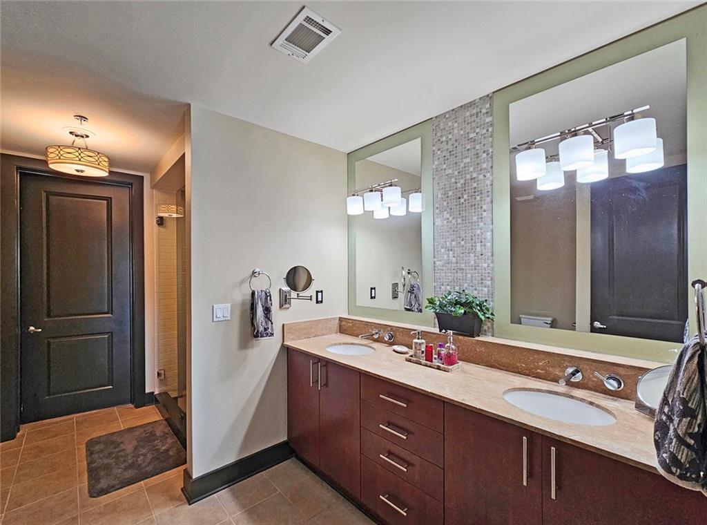4561 Olde Perimeter Way, Unit 1202 Atlanta, GA 30346 - Photo 15 of 46 a spacious bathroom with a double vanity sink and a mirror