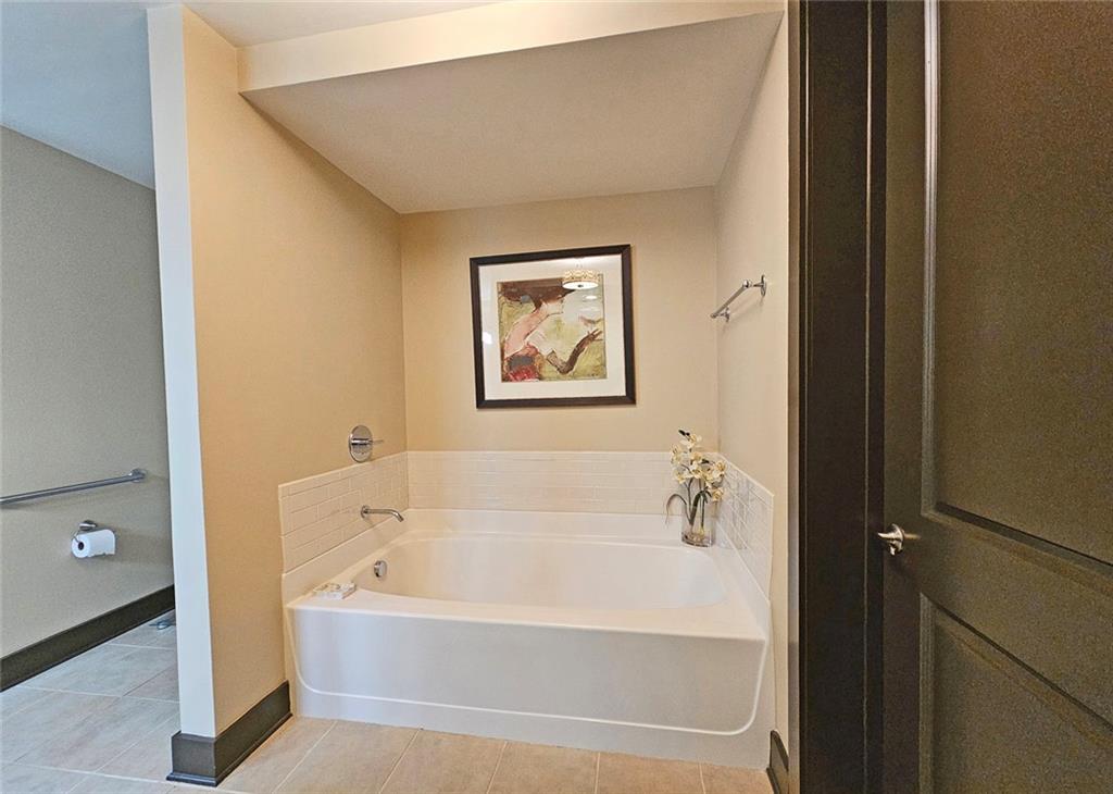 4561 Olde Perimeter Way, Unit 1202 Atlanta, GA 30346 - Photo 17 of 46 a white bath tub sitting next to a white sink