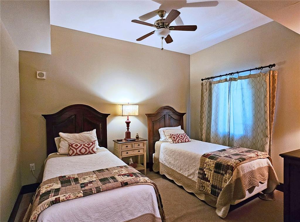 4561 Olde Perimeter Way, Unit 1202 Atlanta, GA 30346 - Photo 18 of 46 a bedroom with bed and a chandelier