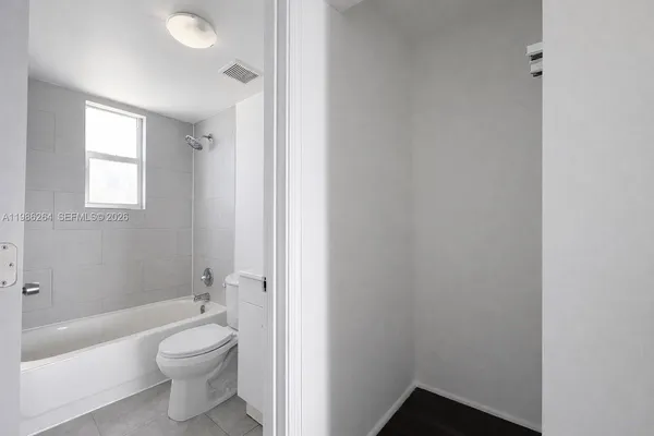a bathroom with a toilet a sink and bathtub