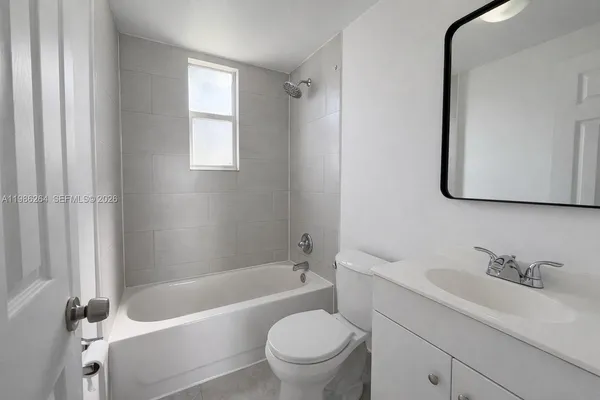 a bathroom with a sink a toilet and a bathtub