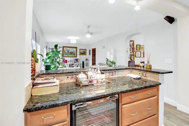 a kitchen with granite countertop a sink and a white stove