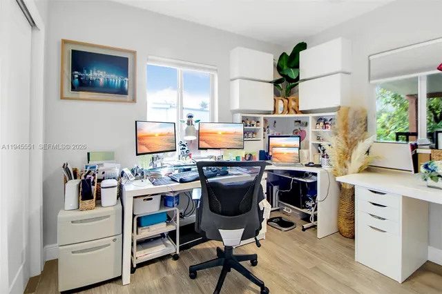 a view of a workspace with furniture and a potted plant