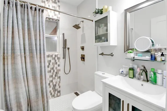 a bathroom with a sink toilet and shower