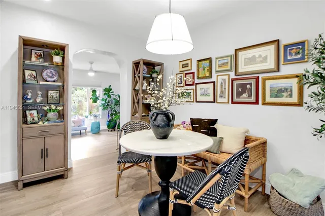 a view of a dining room with furniture wooden floor and a chandelier
