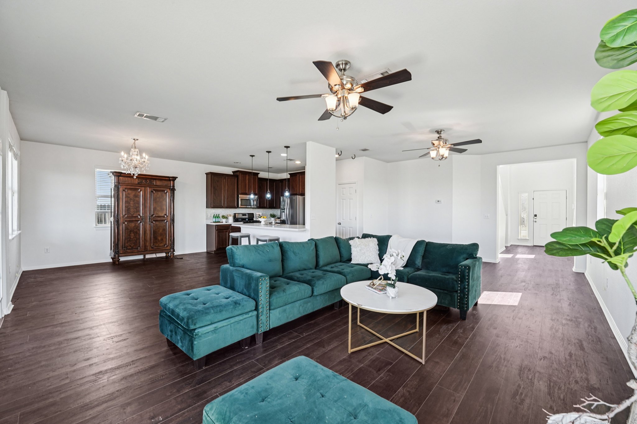 a living room with furniture and a wooden floor
