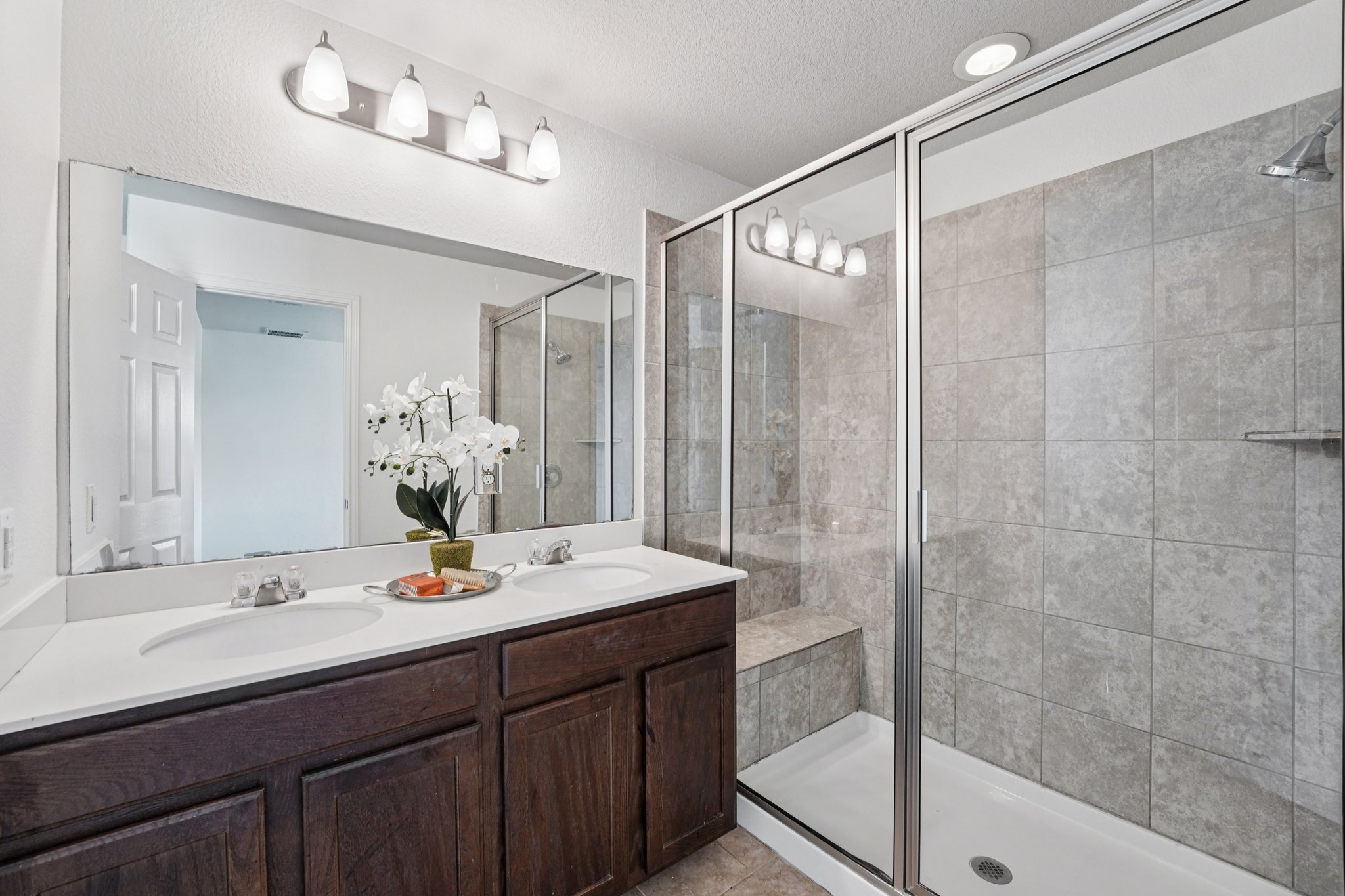 288 Triumph Road Buda, TX 78610 - Photo 11 of 19 a bathroom with a double vanity sink mirror and shower