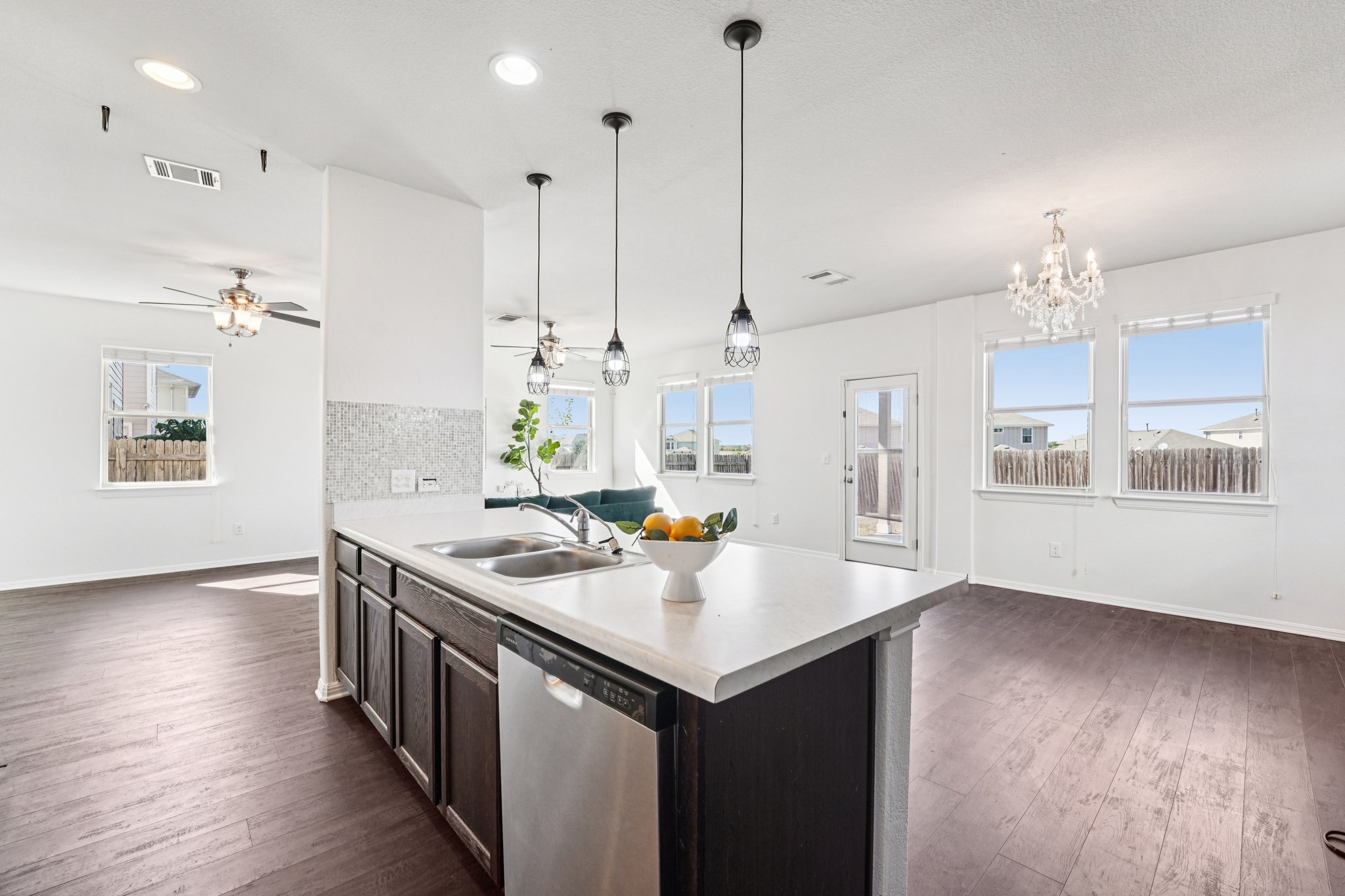 288 Triumph Road Buda, TX 78610 - Photo 2 of 19 a kitchen with sink stove and wooden floor