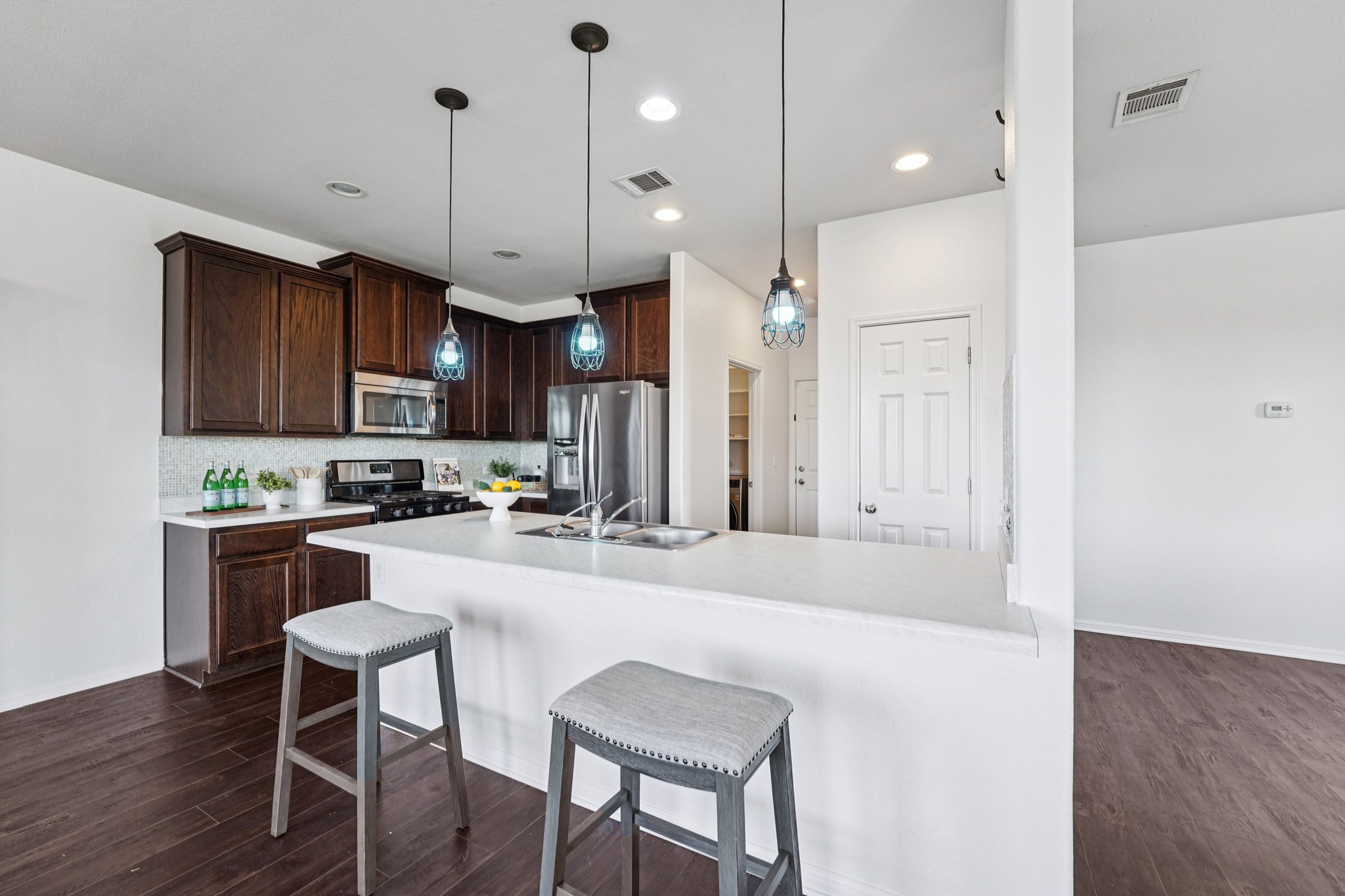 288 Triumph Road Buda, TX 78610 - Photo 4 of 19 a large kitchen with kitchen island a large island in the center